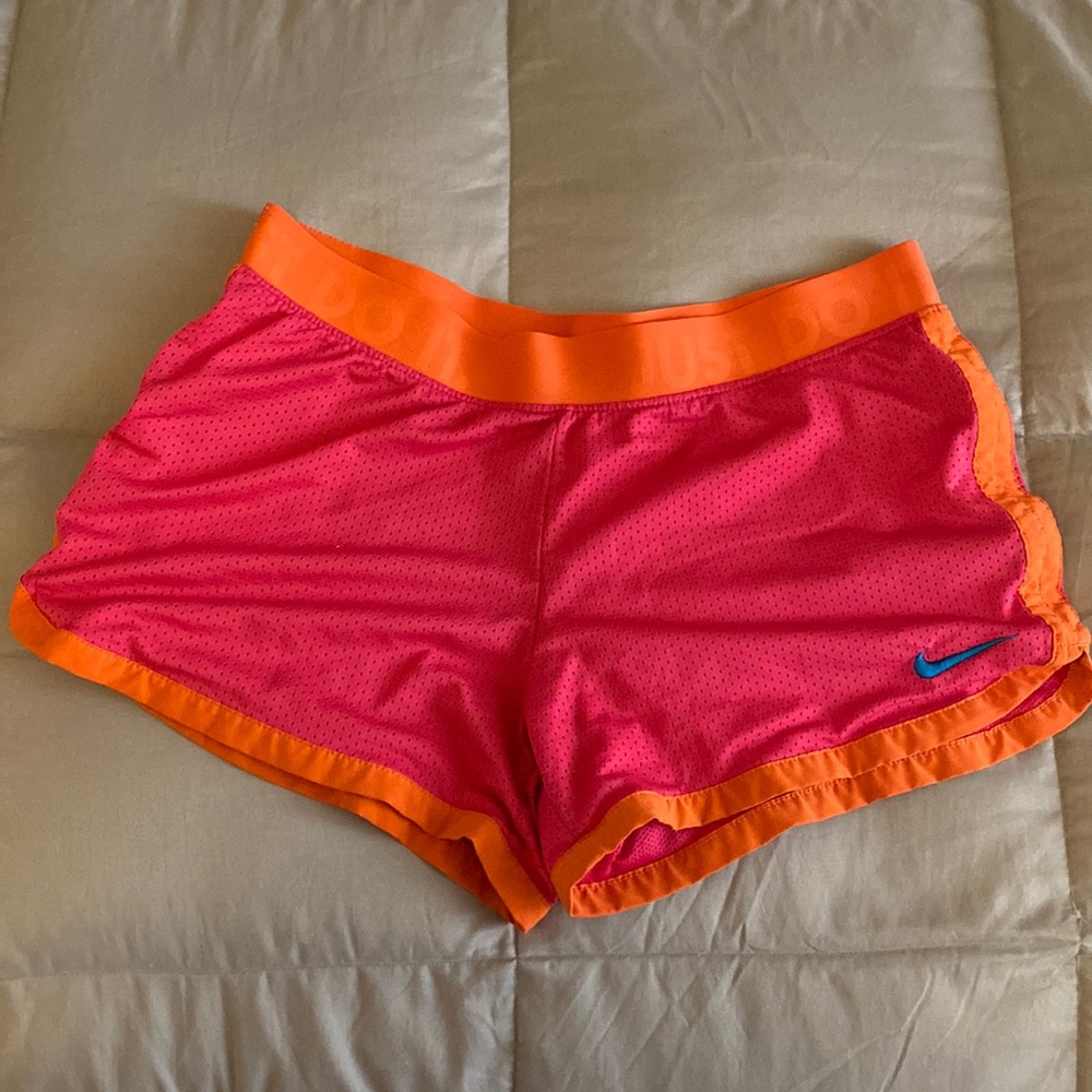 Pink and orange Nike DRI-Fit athletic shorts
